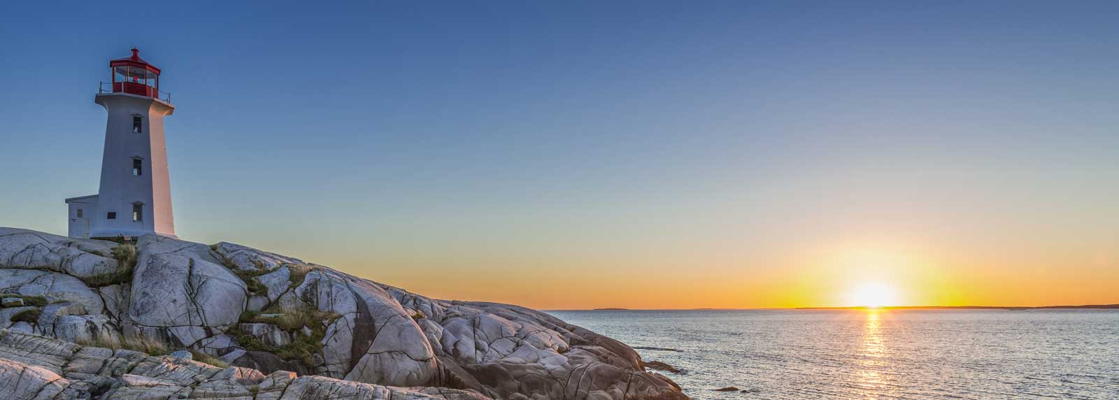 Panorma of Peggys Cove's lighthouse at sunset