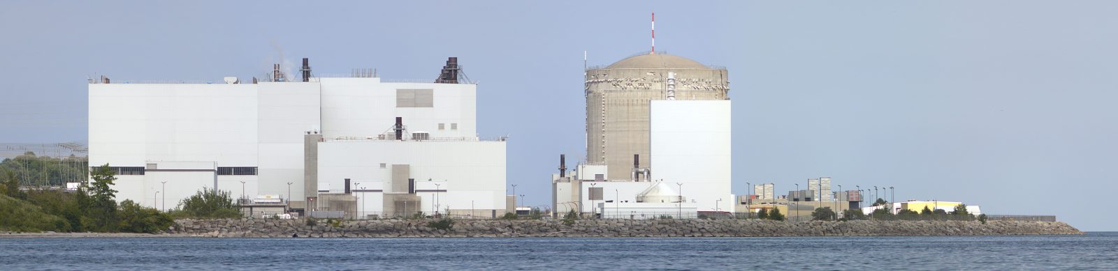 A nuclear plant stands next to a body of water.