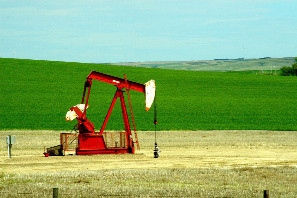 an illustration of an oil well in a field.