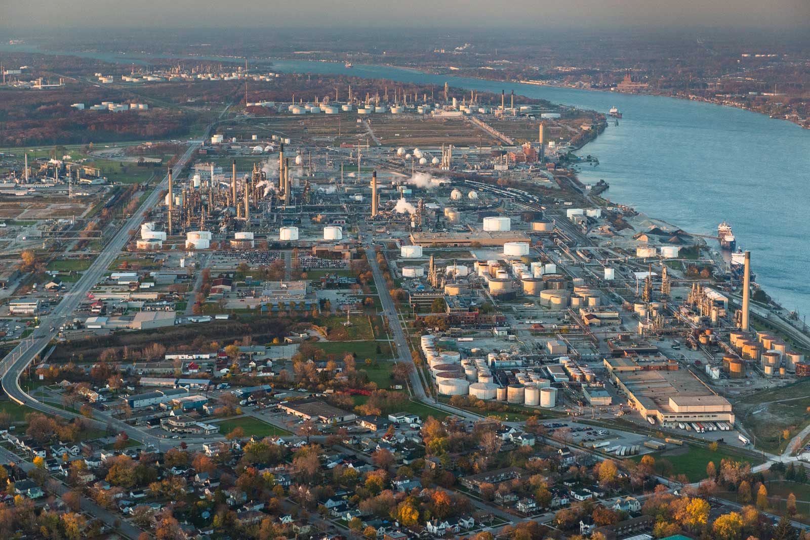 Aerial view of a town and large industrial complexes close to the water.