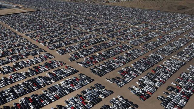 An aerial view of thousands of cars parked in a parking lot.