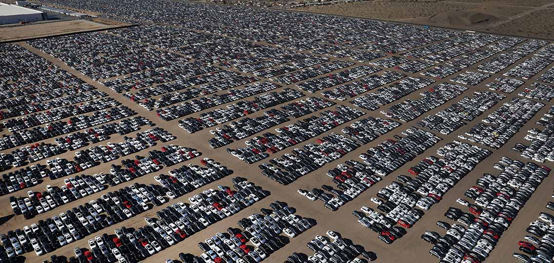 An aerial view of thousands of cars parked in a parking lot.