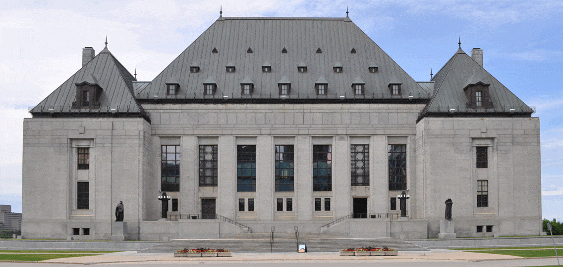 The Supreme Court of Canada building stands in the sunlight.