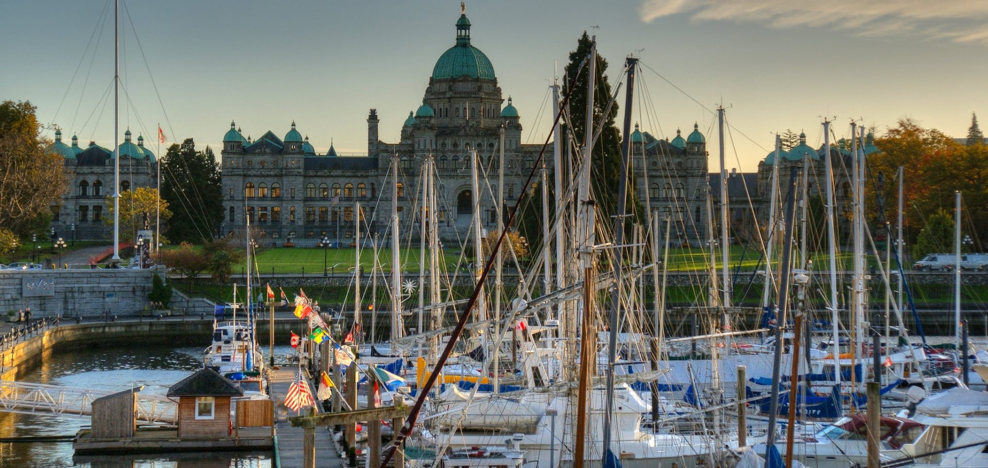 The docks at the Provincial legislature have many docked sail boats. Many boats have a different national flag.