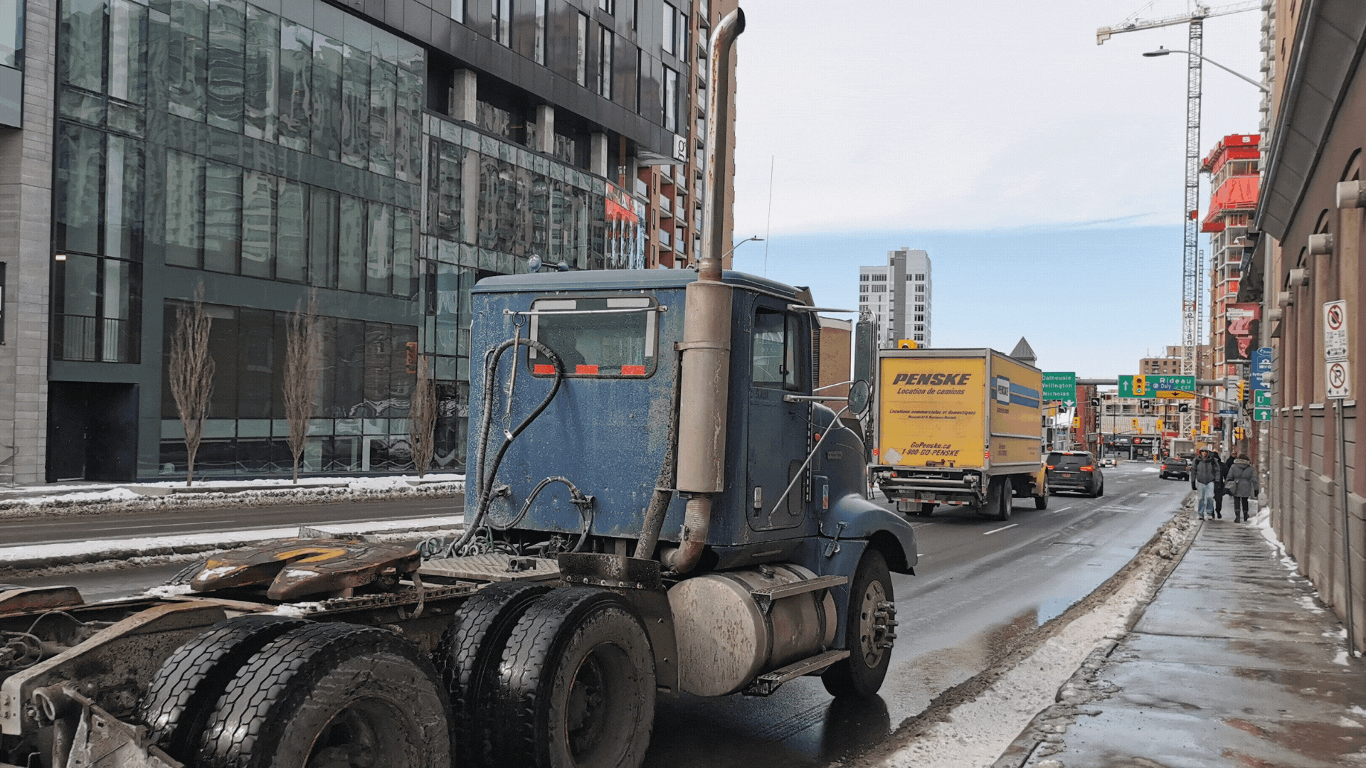 Heavy trucks drive along a trucking corridor that runs through downtown Ottawa.