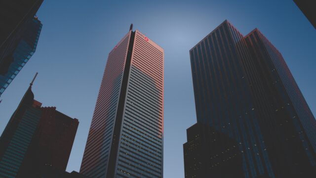 Four large bank buildings reach to the blue sky in Toronto Canada.
