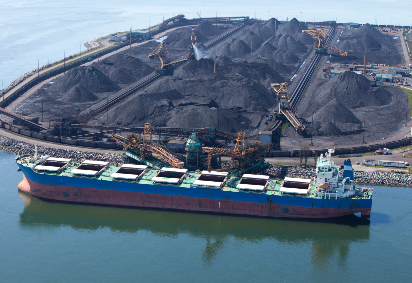 A cargo ship is loaded with coal