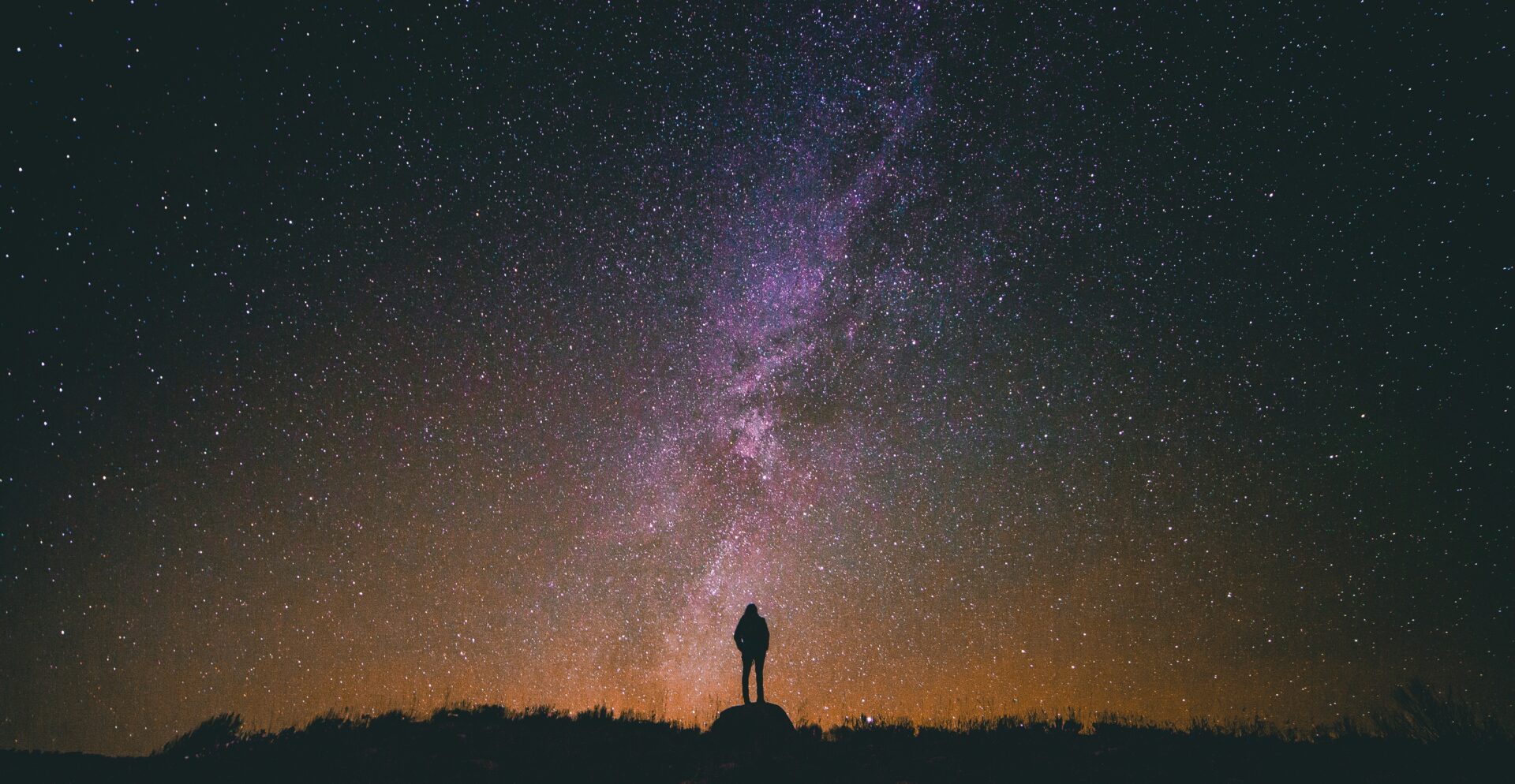 Silhouette of man standing up looking at night's sky