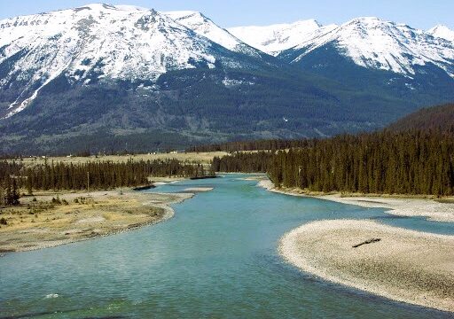 Landscape view of Athabasca River Basin with mountains inthe distance