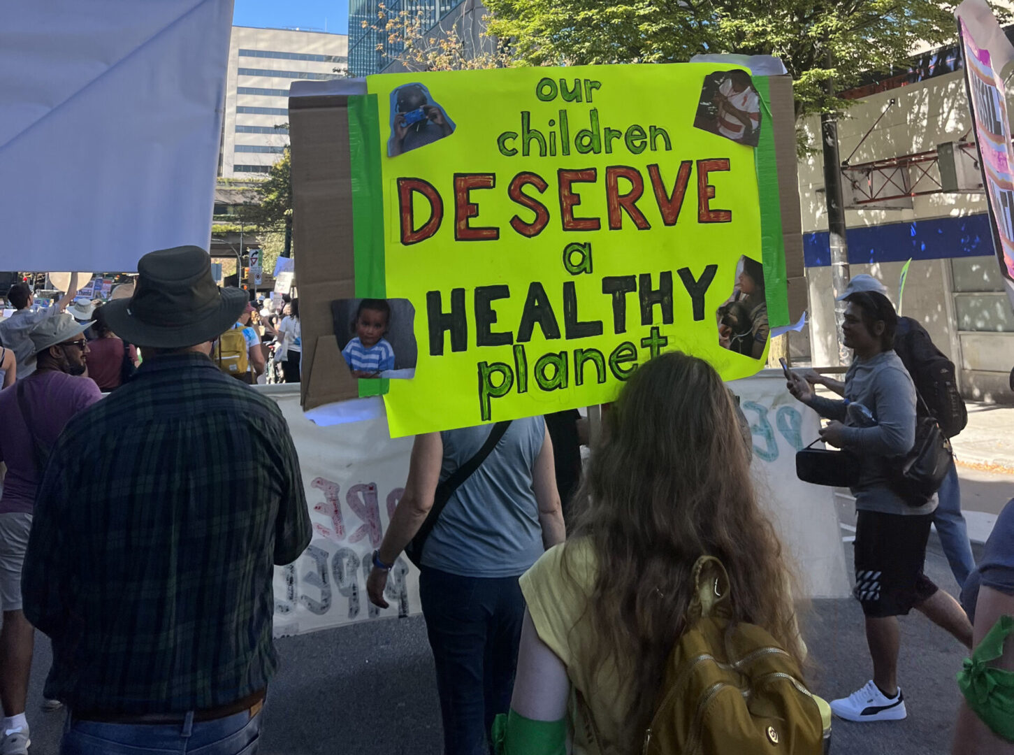 A sign at a climate protest reads our children deserve a healthy planet