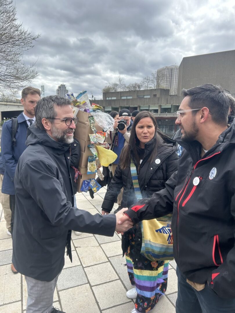 Federal Environment Minister Steven Guilbeault speaking with Janelle Nahmabin and CJ Smith-White, Elected Councillors, Aamjiwnaang First Nations at a rally against plastic pollution in Ottawa.